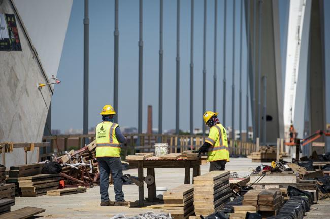 © Bloomberg. Construction workers on the Frederick Douglass Memorial Bridge in Washington, D.C., U.S., on Wednesday, May 19, 2021. The White House said it was 