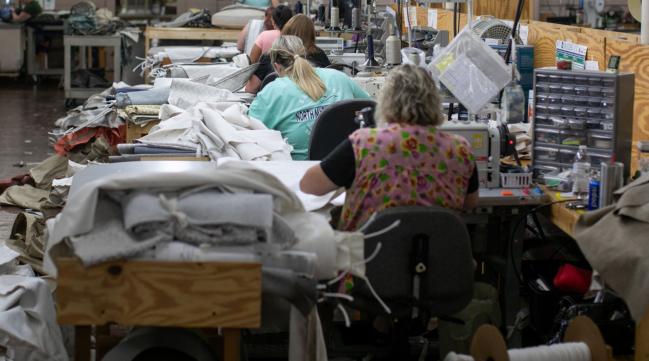 © Bloomberg. Employees sew fabric at a facility in Hickory, North Carolina. Photographer: Logan Cyrus/Bloomberg
