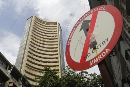 © Reuters/Danish Siddiqui. A road sign is seen next to Bombay Stock Exchange (BSE) building in Mumbai, Aug. 22, 2013.