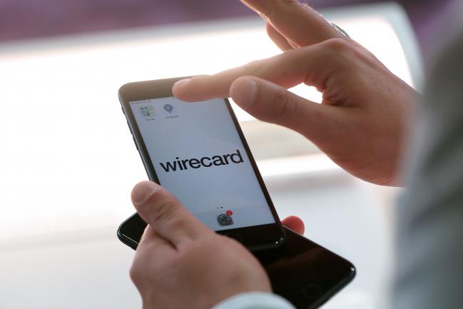 © Bloomberg. An employee demonstrates the Wirecard AG online payment smartphone app on the company's exhibition stand at the Noah Technology Conference in Berlin, Germany, on Thursday, June 13, 2019. The annual tech conference runs June 13 -14 and brings together future-shaping executives and investors. Photographer: Krisztian Bocsi/Bloomberg