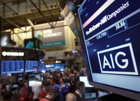 © Reuters/Brendan McDermid. AIG announced job cuts Monday.Pictured: The AIG stock ticker is seen on a monitor as traders work on the floor of the New York Stock Exchange after the opening bell Feb. 11, 2013.
