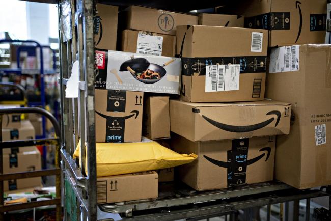 © Bloomberg. Amazon.com Inc. boxes sit at a United States Postal Service (USPS) facility in Fairfax, Virginia, U.S., on Tuesday, May 19, 2020. The Postal Service in recent weeks has sought bids from consulting firms to reassess what the agency charges companies such as Amazon, UPS and FedEx to deliver products on their behalf between a post office and a customer's home, the Washington Post reported last week. Photographer: Andrew Harrer/Bloomberg