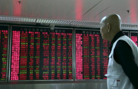 © Reuters/Stringer. An investor looks at an electronic board showing stock information at a brokerage house in Beijing, China, September 16, 2015. China stocks ended up sharply on Wednesday helped by a spike in the final minutes of trade, a frequent phenomenon in mainland markets generally interpreted as government intervention to push up values before the closing bell.