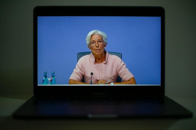 © Bloomberg. A laptop displays Christine Lagarde, president of the European Central Bank (ECB), during a live stream video of the central bank's virtual rate decision news conference in Frankfurt, Germany, in this arranged photograph in London, U.K., on Thursday, Sept. 10, 2020. The European Central Bank kept its emergency monetary stimulus unchanged as the region enters a critical phase in its recovery from the coronavirus crisis. Photographer: Hollie Adams/Bloomberg
