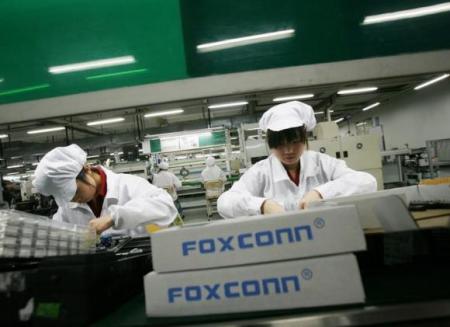 © Reuters/Bobby Yip. Employees work inside a Foxconn factory in the township of Longhua in the southern Guangdong province in this May 26, 2010 file photo.