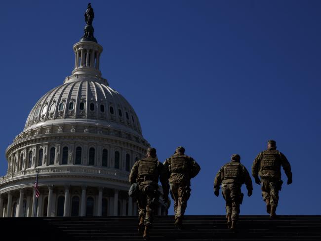 © Bloomberg. Members of the National Guard walk on the U.S. Capitol grounds in Washington, D.C., U.S. on Monday, Feb. 8, 2021. The U.S. Senate is a day away from starting former President Trump's second impeachment trial with many of the details still to be ironed out even as an acquittal is all but assured. Photographer: Ting Shen/Bloomberg
