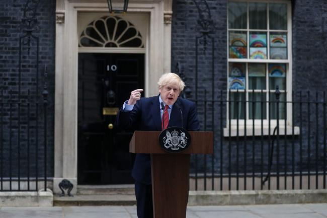 © Bloomberg. Boris Johnson, U.K. prime minister, gestures as he delivers a statement outside number 10 Downing Street in London, U.K., on Monday, April 27, 2020. Johnson is back at work to lead the U.K.'s efforts to tackle the coronavirus, amid calls to ease the lockdown that has brought swathes of the economy to a standstill. Photographer: Simon Dawson/Bloomberg