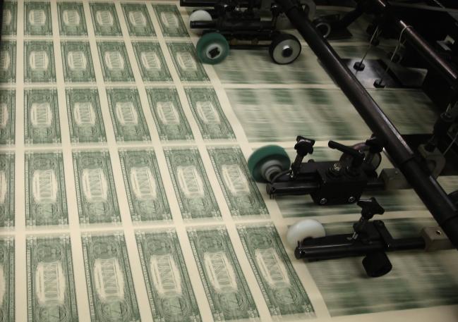© Bloomberg. WASHINGTON, DC - MARCH 24: Sheets of one dollar bills run through the printing press at the Bureau of Engraving and Printing on March 24, 2015 in Washington, DC. The roots of The Bureau of Engraving and Printing can be traced back to 1862, when a single room was used in the basement of the main Treasury building before moving to its current location on 14th Street in 1864. The Washington printing facility has been responsible for printing all of the paper Federal Reserve notes up until 1991 when it shared the printing responsibilities with a new western facility that opened in Fort Worth, Texas. (Photo by Mark Wilson/Getty Images) Photographer: Mark Wilson/Getty Images North America