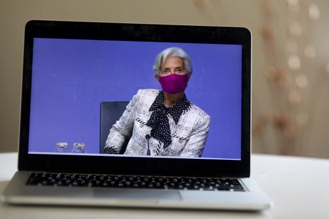 © Bloomberg. Christine Lagarde, president of the European Central Bank (ECB), wears a protective face mask during a live stream video of the central bank's virtual rate decision news conference in Frankfurt, Germany, on a laptop arranged in Danbury, U.K., on Thursday, Oct. 29, 2020. Lagarde said there is “little doubt” that policy makers will agree on a new package of monetary stimulus in December as coronavirus infections and renewed lockdowns threaten a double-dip recession.