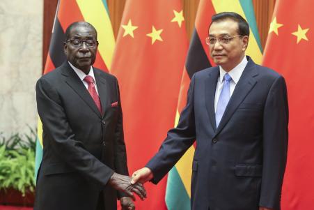 © Diego Azubel-Pool/Getty Images. Zimbabwean President Robert Mugabe (left) and Chinese Premier Li Keqiang (right) during their meeting at the Great Hall of the People in Beijing, China, on August 26, 2014. Mugabe returned from the trip with few commitments for additional aid or investment from Beijing.