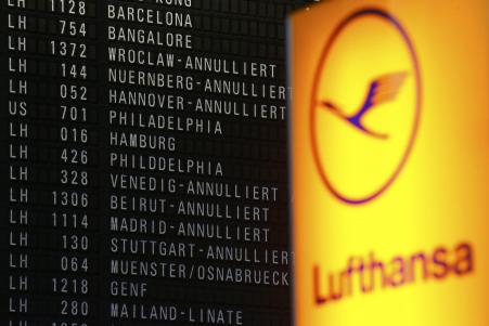 © Reuters/Kai Pfaffenbach. Cancelled flights of German flagship carrier Lufthansa are pictured on an information board in Frankfurt's airport, on Dec. 1, 2014.