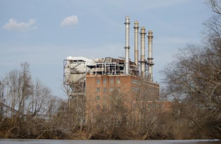 © Reuters/Chris Keane. The Duke Energy coal-fired power plant is seen from the Dan River in Eden, North Carolina Feb. 19, 2014. Duke Energy acquired Piedmont Natural Gas Co. in a .9 billion deal Monday.