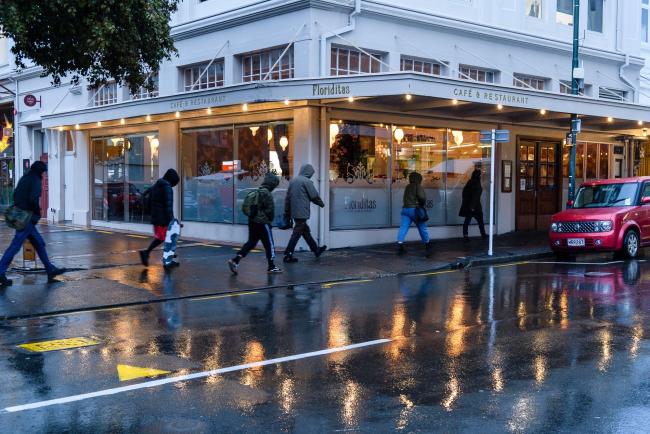 © Bloomberg. Pedestrians walk along a sidewalk past a restaurant in Wellington, New Zealand, on Thursday, June 18, 2020. New Zealand entered recession for the first time in almost a decade as the coronavirus pandemic led to the nations biggest quarterly contraction in 29 years.