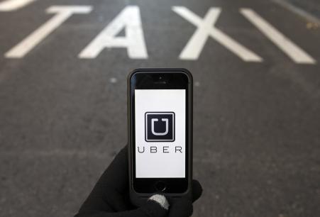 © Reuters/Sergio Perez. The logo of car-sharing service Uber, which said it will be doing more extensive background checks on its drivers.