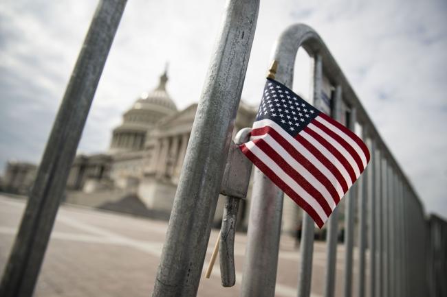 © Bloomberg. WASHINGTON, DC - SEPTEMBER 28: An American flag is placed on a fence outside of the U.S. Capitol building on September 28, 2020 in Washington, DC. This week Seventh U.S. Circuit Court Judge Amy Coney Barrett, U.S. President Donald Trump's nominee to the Supreme Court, will begin meeting with Senators as she seeks to be confirmed before the presidential election. (Photo by Al Drago/Getty Images) Photographer: Al Drago/Getty Images North America