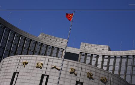 © Reuters/Petar Kujundzic. A Chinese national flag flutters outside the headquarters of the People's Bank of China, the Chinese central bank, in Beijing on April 3, 2014.