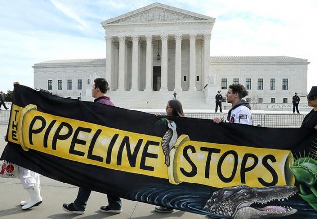 © Bloomberg. Demonstrators protest against the Atlantic Coast Pipeline in front of the U.S. Supreme Court in Washington, D.C., on Feb. 24. Photographer: Mark Wilson/Getty Images North America