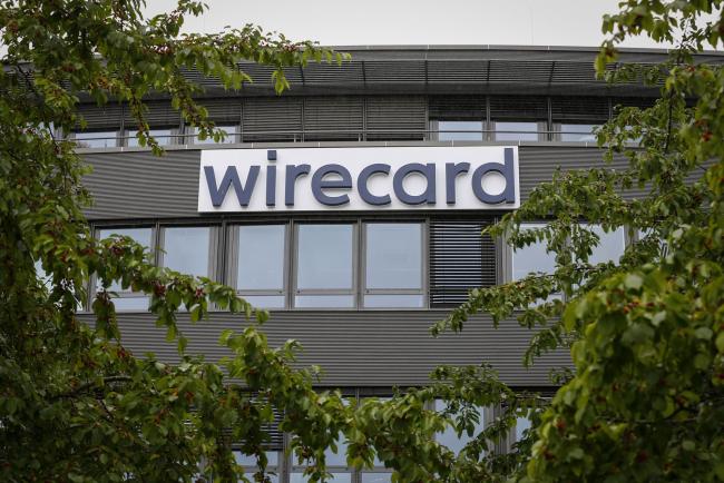 © Bloomberg. A sign hangs outside the Wirecard AG headquarters in the Aschheim district of Munich, Germany, on Friday, June 19, 2020. Wirecard shares continued their free-fall after the two Asian banks that were supposed to be holding 1.9 billion euros ($2.1 billion) of missing cash denied any business relationship with the German payments company. Photographer: Michaela Handrek-Rehle/Bloomberg