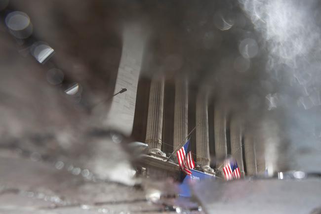 © Bloomberg. The New York Stock Exchange (NYSE) is reflected in a puddle in New York, U.S., on Friday, Oct. 2, 2020. New York faced pressure as middle and high schools reopened, infection rates in virus hot spots rose further and the city's bond rating was cut by Moody's. Photographer: Michael Nagle/Bloomberg