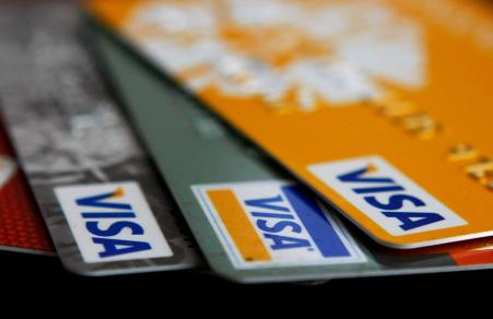 © Getty Images/Justin Sullivan. American multinational financial services company Visa Inc will report its fourth quarter and full-year profits before markets open Monday. Here, Visa credit cards are arranged on a desk February 25, 2008 in San Francisco, California.