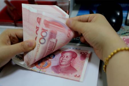 © Getty Images/STR/AFP. On Thursday, as the Yuan fell for the third straight day, the People's Bank of China (PBOC) said that the currency would strengthen again once the markets stabilize, adding that there is 'no basis' for further depreciation. Pictured: A teller counts yuan banknotes in a bank in Lianyungang, east China's Jiangsu province on August 11, 2015.