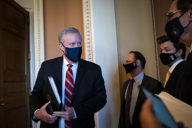 © Bloomberg. Mark Meadows, White House chief of staff, left, and Steven Mnuchin, U.S. Treasury secretary, right, wear protective masks after a meeting at the U.S. Capitol in Washington, D.C., U.S., on Wednesday, July 29, 2020. President Donald Trump said that Republicans and Democrats aren't close to resolving their differences over a coronavirus stimulus package, and that Congress may need to pass some stopgap measures to prevent aid from running out.
