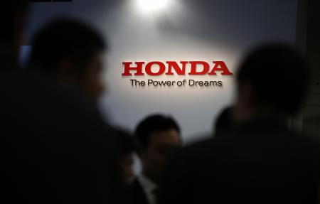 © Reuters/Toru Hanai. A logo of Honda Motor Co is seen behind journalists after the unveiling event for the company's all-new hybrid sedan 'Grace' in Tokyo December 1, 2014.