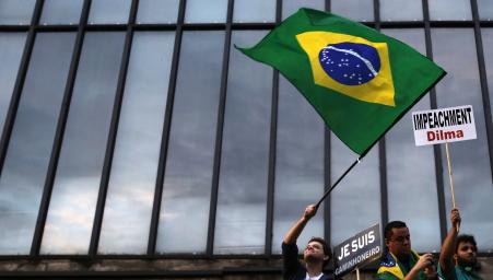 © Reuters/Nacho Doce. Standard and Poor's downgraded Brazil's credit rating to 'junk' Wednesday, revoking the country's investment-grade rating awarded in 2008. Pictured: Demonstrators march in a protest against Brazil's President Dilma Rousseff at Paulista avenue in Sao Paulo March 15, 2015.