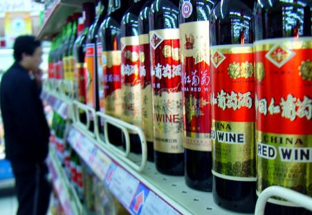 © Reuters/Jason Lee. A sharp decline in Chinese imports, according to trade data released Oct. 13, 2015, highlight continuing concerns about a slowdown in domestic demand in the world's second largest economy. Pictured: A Chinese consumer looks at bottles of red wine in a supermarket in Beijing on Oct. 26, 2005.