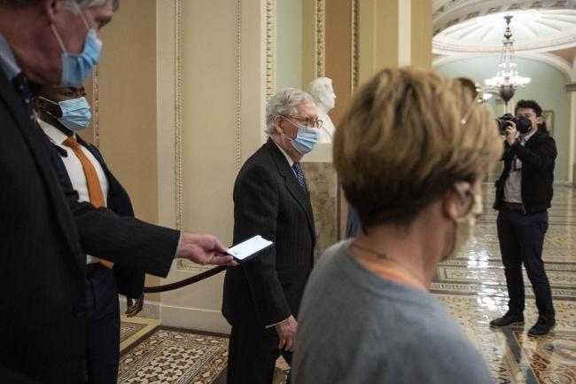 © Bloomberg. Senate Majority Leader Mitch McConnell, a Republican from Kentucky, walks to the Senate floor at the U.S. Capitol in Washington, D.C., U.S., on Tuesday, Dec. 15, 2020. Democratic leaders Pelosi and Schumer face pressure to allow a vote on a Covid-19 assistance plan without the aid for states they've said is vital, after a bipartisan group split that and liability protections from other relief spending.