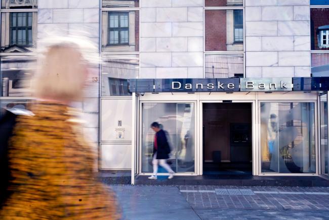 © Bloomberg. Pedestrians pass a Danske Bank A/S bank branch in Aalborg, Denmark, on Monday, Sept. 14, 2020. Denmark is re-introducing a number of coronavirus-related restrictions following the worst spike in infections since the height of the pandemic.