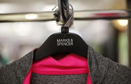 © Reuters/Suzanne Plunkett. Clothes are displayed on hangers in an M&S shop in northwest London on July 8, 2014.