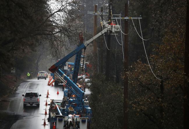 © Bloomberg. PARADISE, CALIFORNIA - NOVEMBER 21: Pacific Gas and Electric (PG&E) crews repair power lines that were destroyed by the Camp Fire on November 21, 2018 in Paradise, California. Fueled by high winds and low humidity the Camp Fire ripped through the town of Paradise charring over 150,000 acres, killed at least 81 people and has destroyed over 18,000 homes and businesses. The fire is currently at 80 percent containment and hundreds of people still remain missing. (Photo by Justin Sullivan/Getty Images) Photographer: Justin Sullivan/Getty Images North America