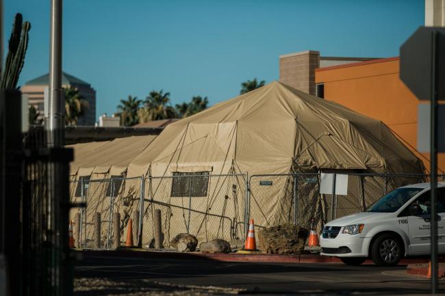 © Bloomberg. Temporary medical tents stand outside a hospital in Phoenix on June 17.