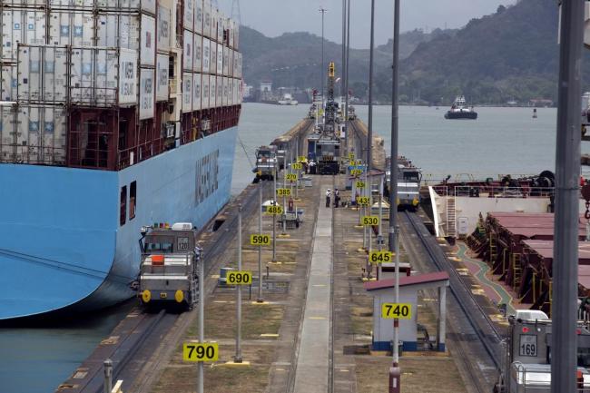 © Bloomberg. The Maersk container ship Bali, left, and the CMB Coralie bulk carrier, right, are guided through the Miraflores locks at the Panama Canal, near Panama City, Panama. Photographer: Susana Gonzalez/Bloomberg