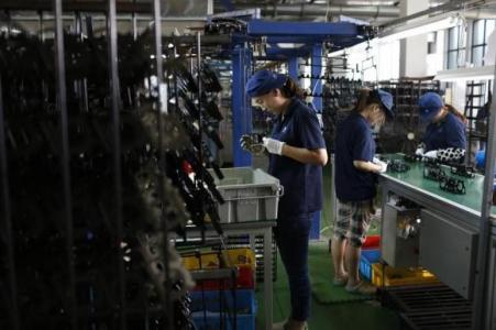 © Reuters/Aly Song. Employees work at a factory inside the Japan Automotive Parts Industrial Center (JAPIC), in Danyang, Jiangsu province on July 8, 2014.