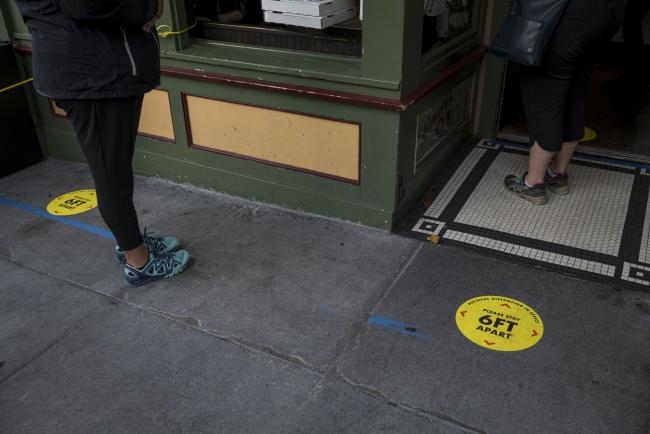 © Bloomberg. Social distance markers are displayed on the ground in front of a restaurant in San Francisco on June 15. Photographer: David Paul Morris/Bloomberg