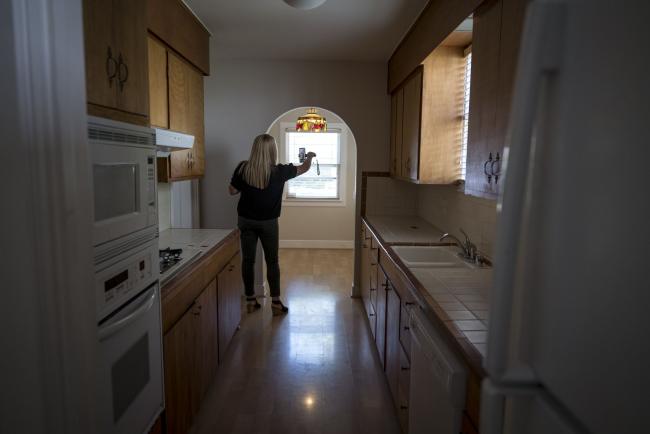 © Bloomberg. A realtor wearing a protective mask uses a smartphone to provide a virtual video tour of a home for sale in Sacramento, California.