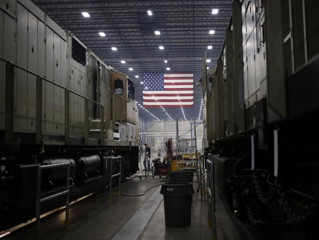 © Bloomberg. An American flag hangs as General Electric Co. (GE) Evolution Series Tier 4 diesel locomotives stand on the final assembly line at the GE Manufacturing Solutions facility in Fort Worth, Texas, U.S., on Tuesday, Oct. 25, 2016. The U.S. Census Bureau is scheduled to release durable goods figures on October 27. Photographer: Bloomberg/Bloomberg