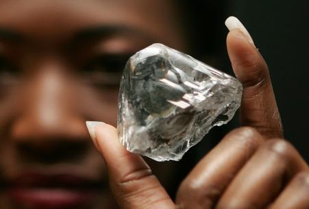 © Reuters/Francois Lenoir. A model displays a rare 603 carat white diamond sold for .36 million during a news conference in Antwerp, October 9, 2006. The diamond, the 'Lesotho Promise', will be cut up and sold for an expected  million.