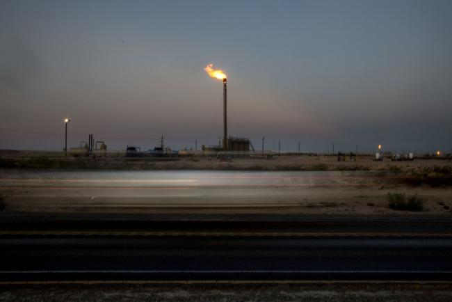 © Bloomberg. Gas flares stand in a field as light trails from a passing vehicle are seen on Highway 285 near Orla, Texas, U.S., on Saturday, Aug. 31, 2019. Natural gas futures headed for the longest streak of declines in more than seven years as U.S. shale production outruns demand and inflates stockpiles. Photographer: Bronte Wittpenn/Bloomberg