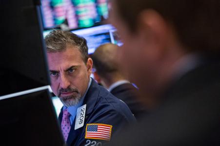 © Getty Images/Andrew Burton. A trader works on the floor of the New York Stock Exchange during the afternoon of Sept. 28, 2015, in New York City.