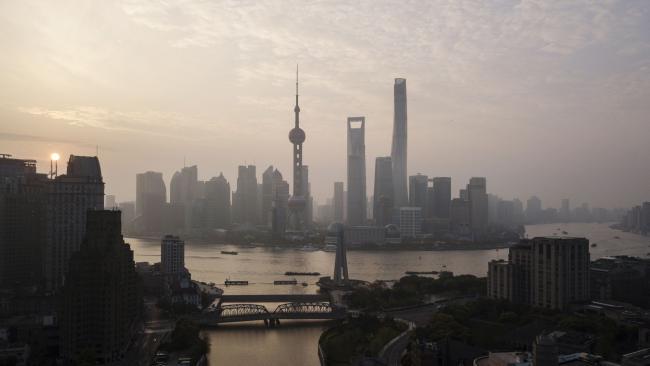 © Bloomberg. The Oriental Pearl Tower, center left, Shanghai World Financial Center, center, and the Shanghai Tower, center right, stand among other buildings in the Lujiazui Financial District along the Pudong riverside in this aerial photograph taken above Shanghai, China, on Monday, April 2, 2018. China's sprawling local government financing system needs 