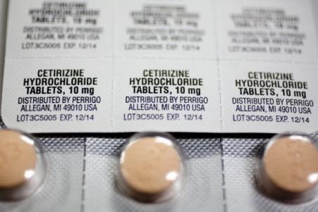 © Bloomberg/Andrew Harrer. Perrigo may defeat Mylan's hostile takeover bid, according to reports. Pictured: Blister packs of over-the-counter allergy medicines, manufactured by Perrigo Co., in Washington, D.C., July 29, 2013.