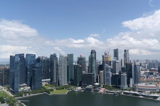 © Bloomberg. Buildings stand in the Central Business District in Singapore on Monday, July 6, 2020. Prime Minister Lee Hsien Loong vowed to hand over Singapore “intact” and in “good working order” to the next generation of leaders, predicting the coronavirus crisis will “weigh heavily” on the nation’s economy for at least a year. Photographer: Wei Leng Tay/Bloomberg