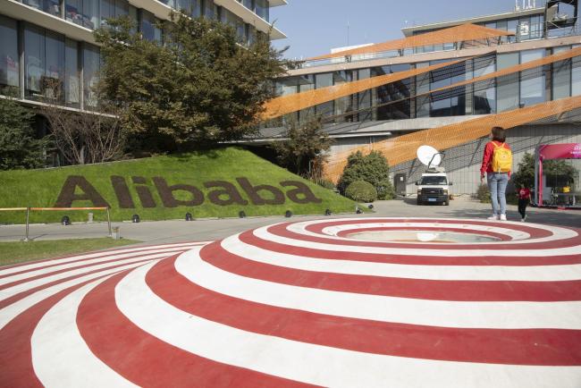 © Bloomberg. Employees walk through the campus at the Alibaba Group Holding Ltd. headquarters during the annual November 11 Singles' Day online shopping event in Hangzhou, China, on Monday, Nov. 11, 2019. Alibaba's Singles' Day shopping bonanza got off to a scorching start, logging more than 114 billion yuan ($16.3 billion) of purchases in less than 90 minutes, the equivalent of more than half of last year’s record haul for the 24-hour event. Photographer: Qilai Shen/Bloomberg