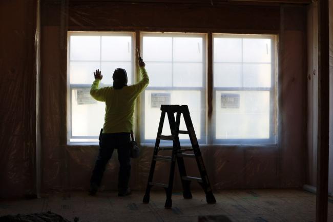 © Bloomberg. A contractor installs wall insulation in a home under construction in Park City, Utah on Aug. 14. Photographer: George Frey/Bloomberg