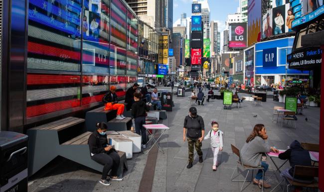 © Bloomberg. People sit in a seating area in Times Square in New York, U.S., on Friday, Oct. 2, 2020.