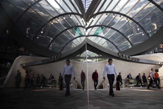 © Bloomberg. Commuters are reflected in a surface as they exit Wynyard Station in Sydney, Australia, on Monday, Nov. 11, 2019. Australia is bracing for more devastating bushfires, with swaths of the eastern seaboard and even areas of greater Sydney facing a 