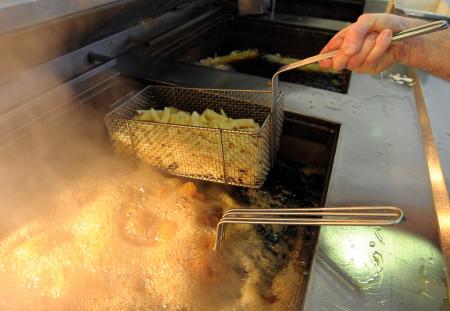 © Getty Images/AFP/Paul Ellis. Pictured: Chips are fried at a Fish and Chip Takeaway in Manchester, north-west England, on March 10, 2010.